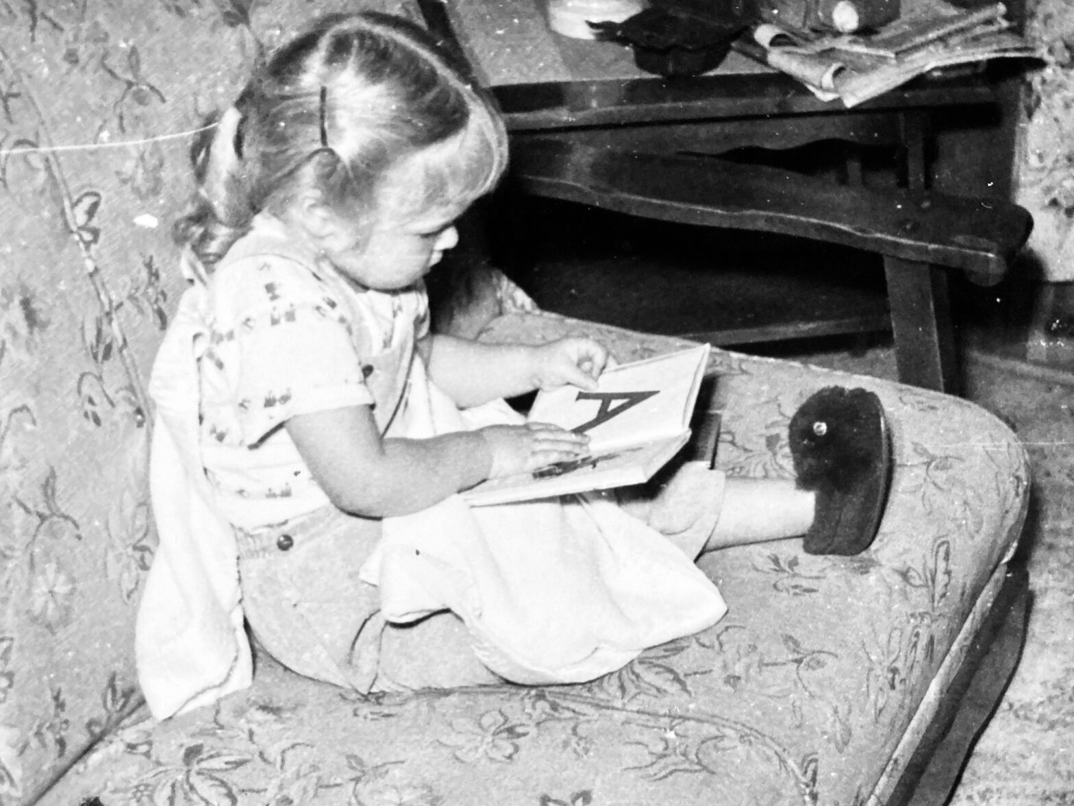 Little girl viewing an alphabet book